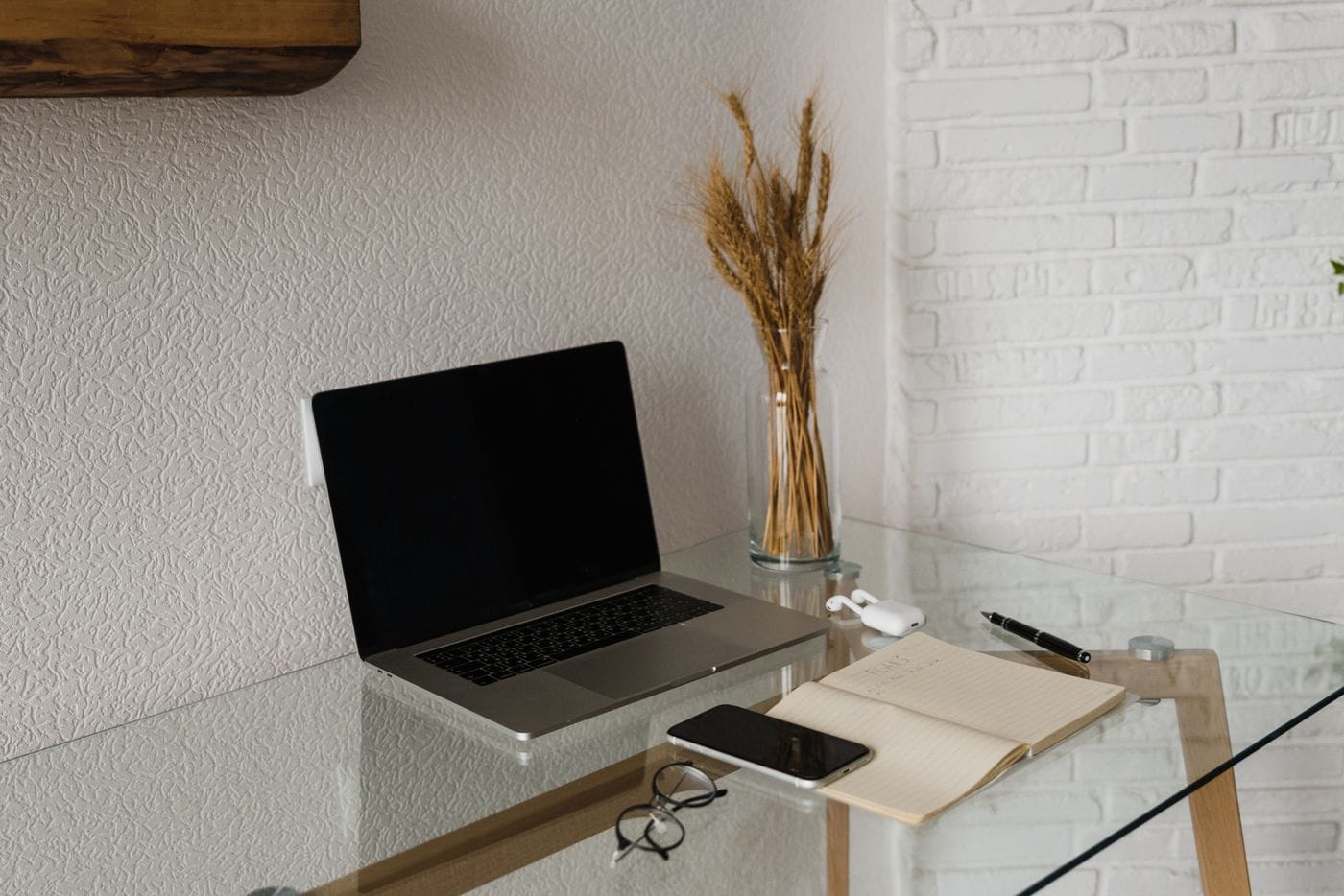 A notebook and devices on a desk, illustrating preparation