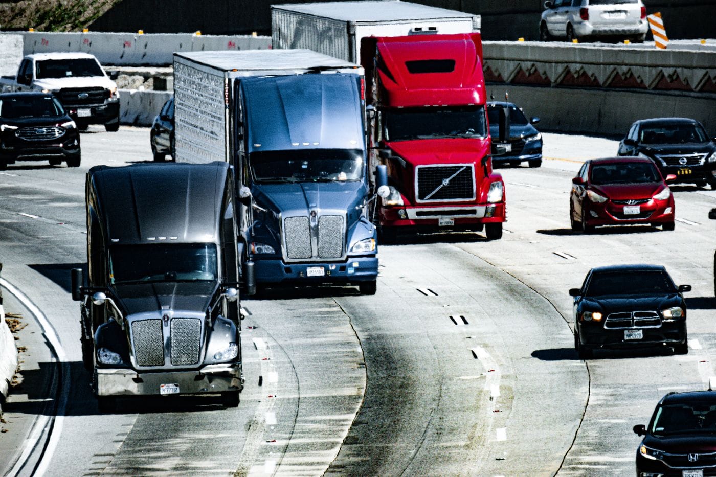Commercial trucks traveling on a US highway; editorial photography